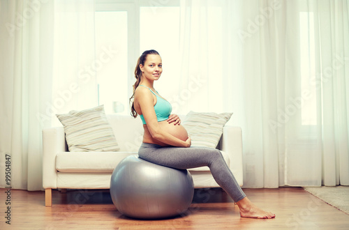 happy pregnant woman exercising on fitball at home Free Download happy pregnant woman exercising on fitball at home - GFXLoad