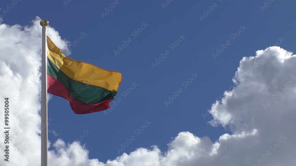 National flag of Lithuania waving on the pole against blue sky and white clouds on a sunny day National flag of Lithuania waving on the pole against blue sky and white clouds on a sunny day