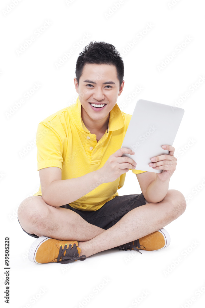 Happy young man using digital tablet Happy young man using digital tablet