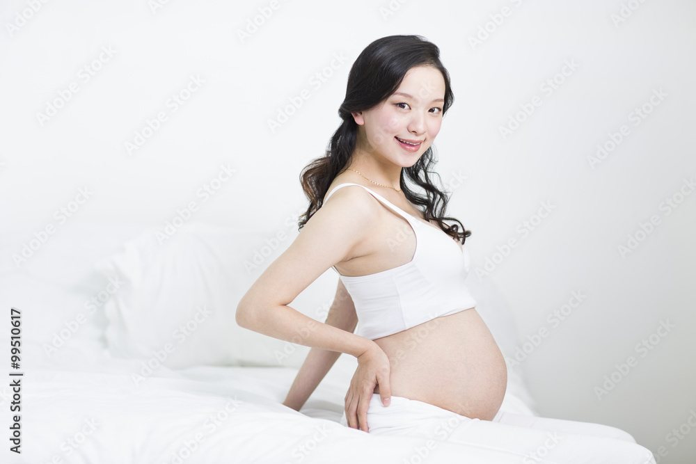 Doctor measuring pregnant woman's abdomen Doctor measuring pregnant woman's abdomen