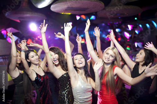 Stylish young people dancing in nightclub