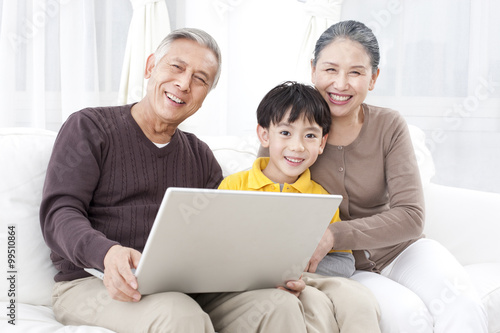 Grandparents and grandson using laptop