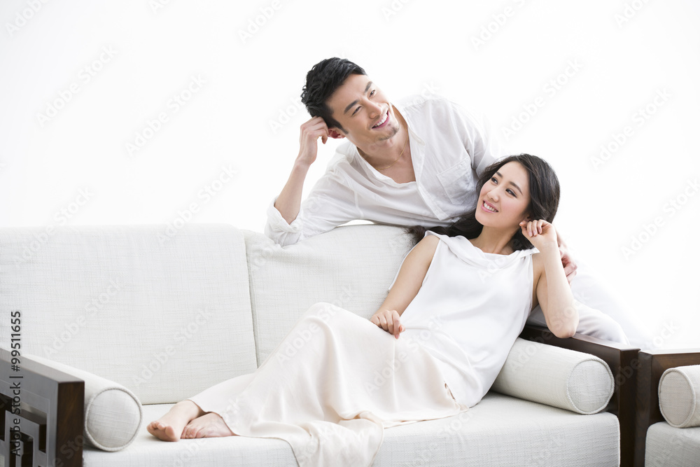 Happy young couple relaxing at home