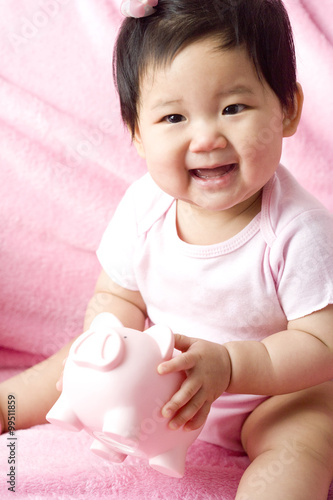 Baby playing with the piggybank