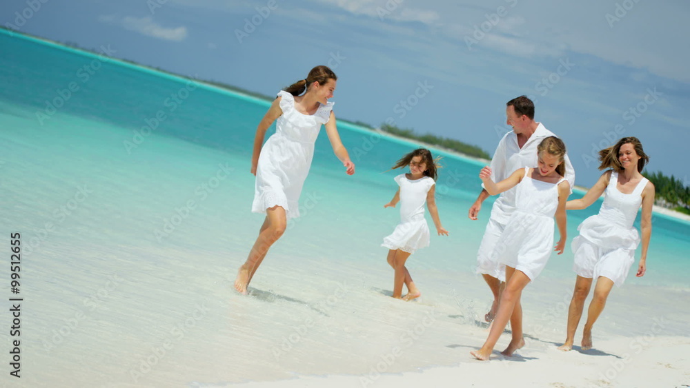 Caucasian family parents girls white clothes beach ocean island vacation tourism Caucasian family parents girls white clothes beach ocean island vacation tourism