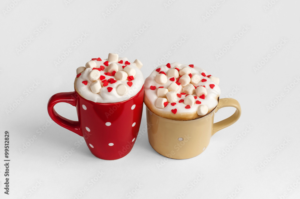 Two cups of cappuccino with marshmallow and sugar hearts