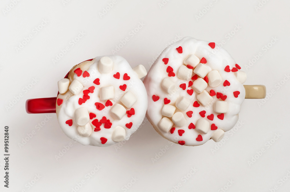 Two cups of cappuccino with marshmallow and sugar hearts