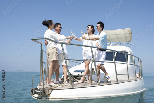 Friends Toasting Champagne on a Yacht © Blue Jean Images