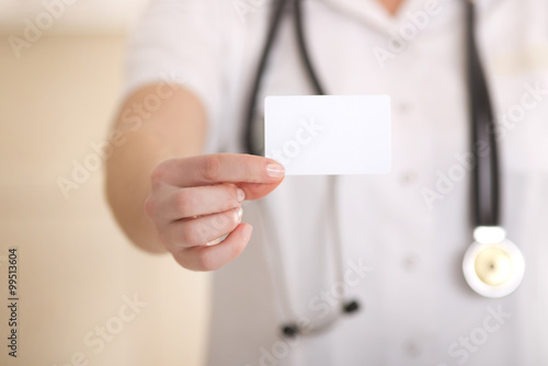 Female doctor showing blank business card