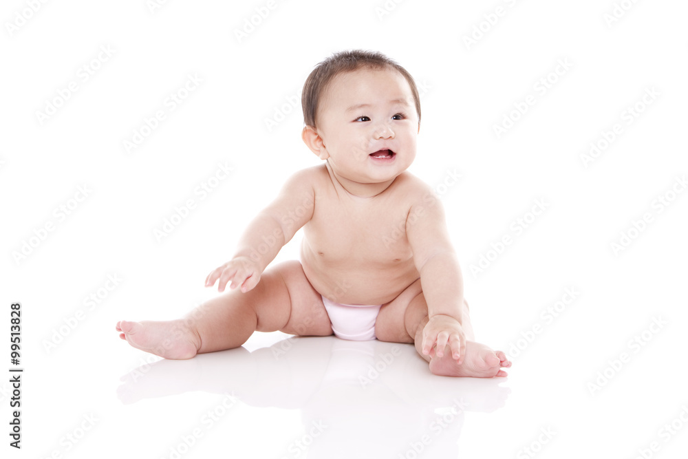 Studio shot of cute baby sitting on floor Studio shot of cute baby sitting on floor