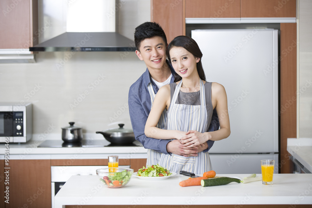 Young couple cooking in the kitchen Young couple cooking in the kitchen