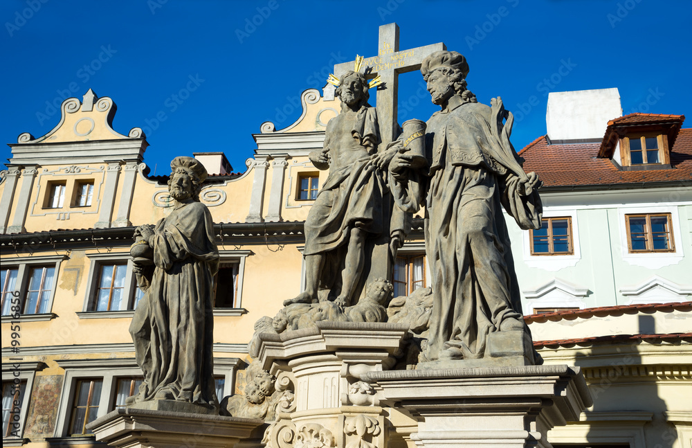 Savior and holy Cosmas and Damian statue on the Charles Bridge in Prague