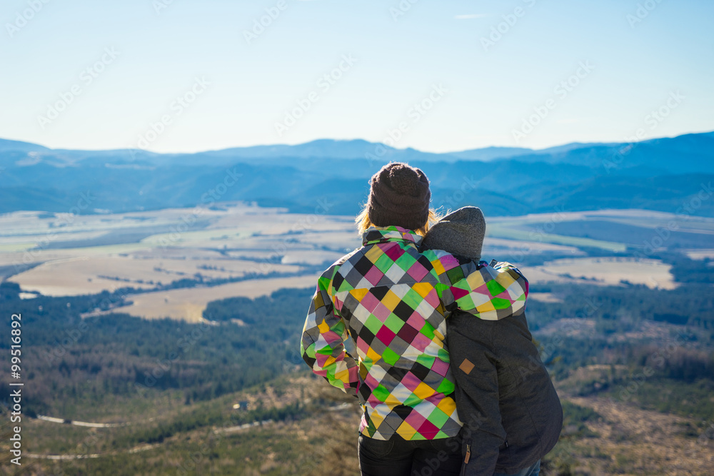 Two friends enjoy the panoramic view from High Tatras in Slovakia