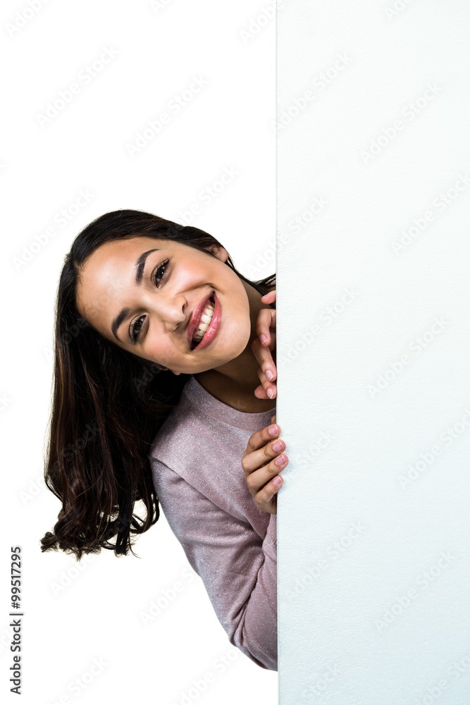 Close-up of smiling woman behind board Close-up of smiling woman behind board