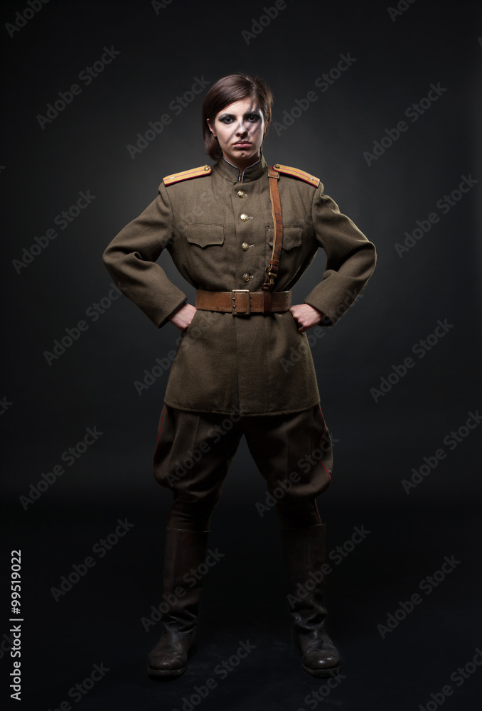 Sexy woman in military uniform. Studio shot. Black background