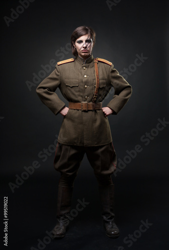 Sexy woman in military uniform. Studio shot. Black background