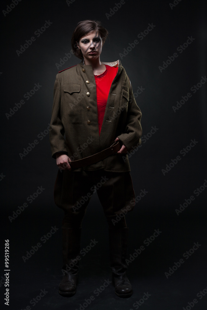 Obraz premium Sexy woman in military uniform. Studio shot. Black background