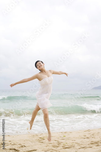A woman dancing at the beach