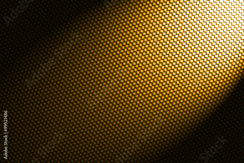 spotlight on yellow carbon fiber background.