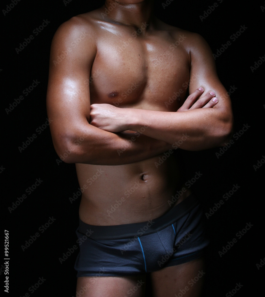 front view of the body of a hunky young asian in blue trunks