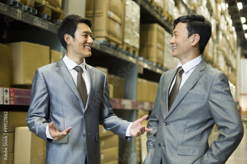 Business partners talking in logistic warehouse