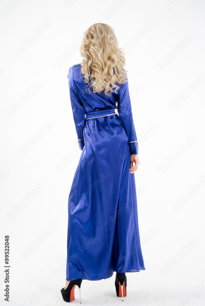 A woman in a blue, long gown on a white background