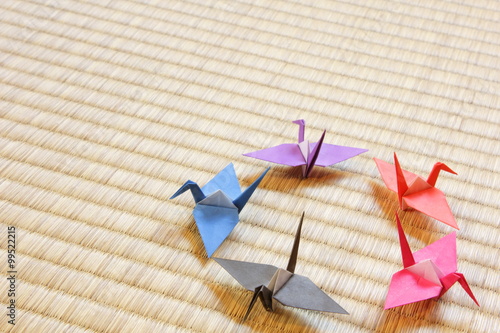 Photography Colorful paper cranes on Japanese Tatami flooring mat