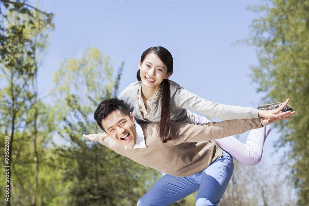 Excited young couple pretending to be a plane Excited young couple pretending to be a plane