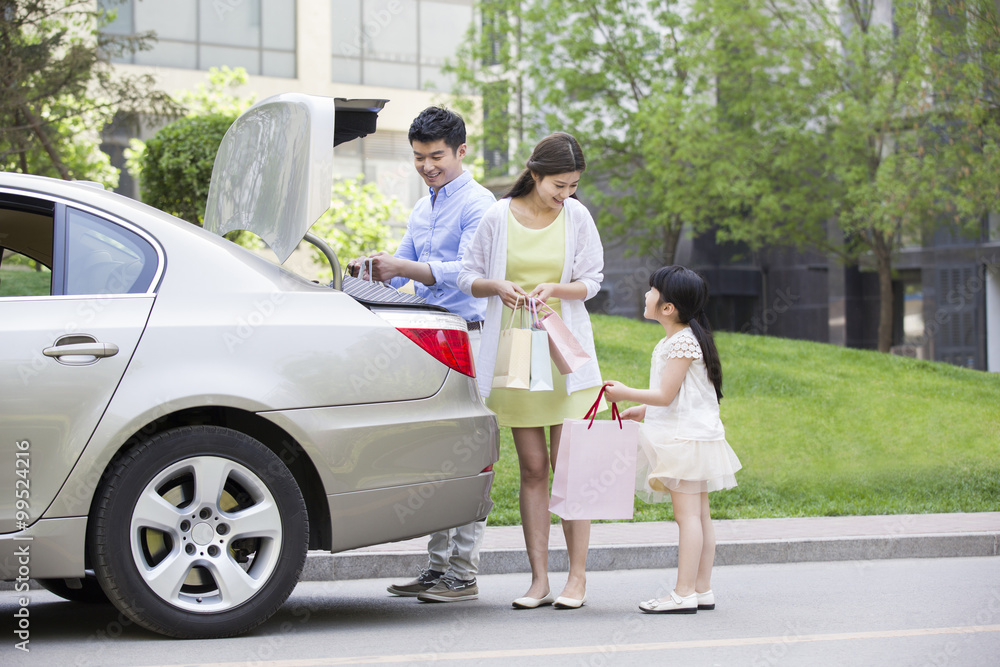 Obraz premium Young family coming back from shopping
