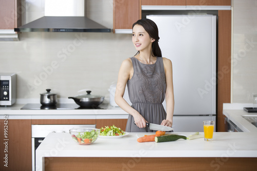 Young woman cooking in the kitchen