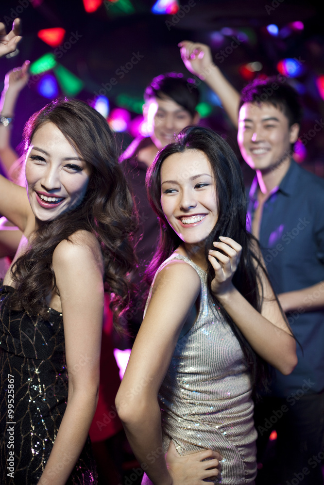 Stylish young people dancing in nightclub