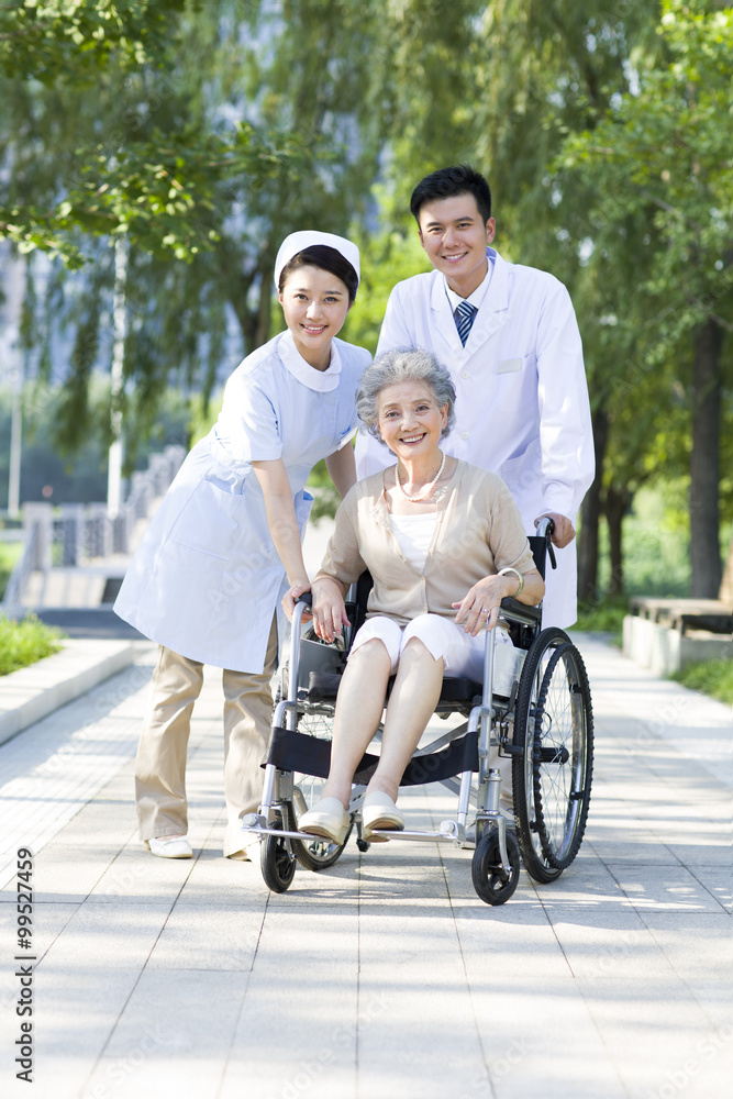 Doctor, nurse and wheelchair bound patient Doctor, nurse and wheelchair bound patient