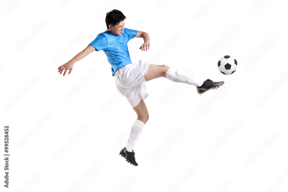 Soccer player kicking while jumping