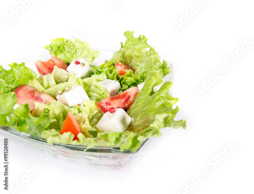 Green salad isolated on white. Close up of diverse vegetables