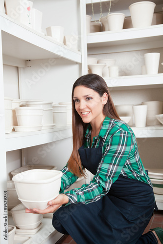 Woman showing a ceramic product