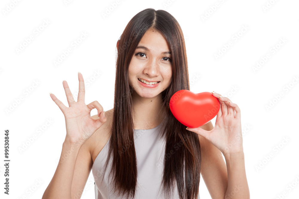 Beautiful young Asian woman show OK with red heart Beautiful young Asian woman show OK with red heart