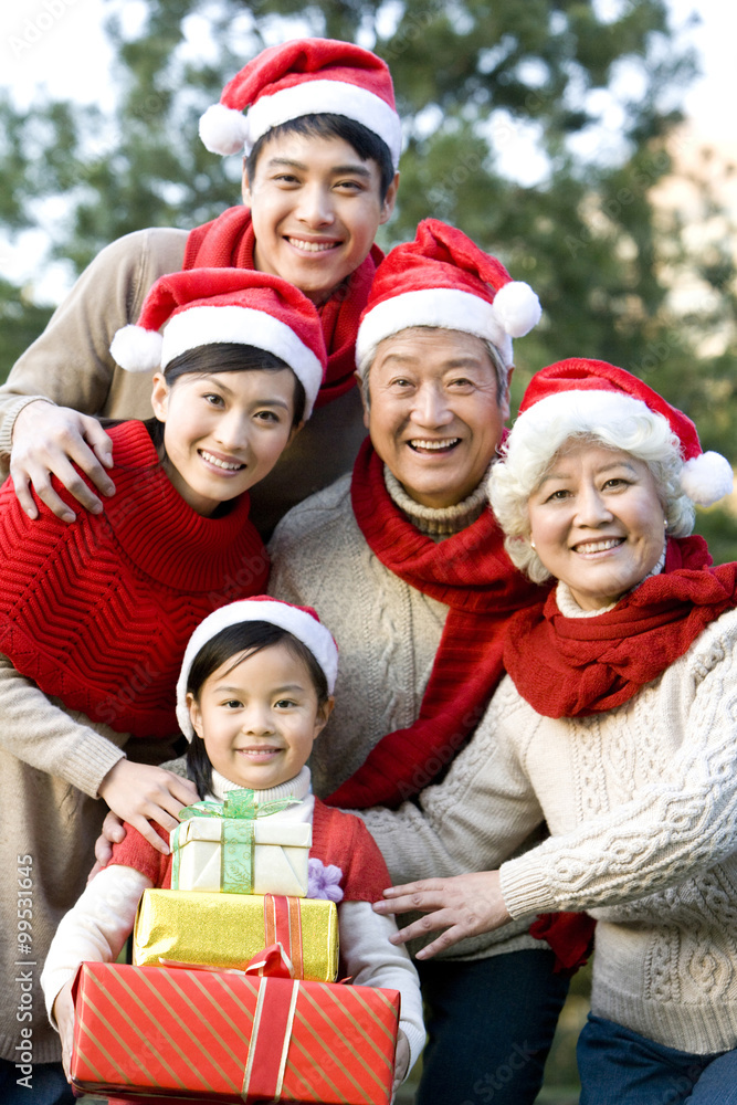 Multi Generation Family Wearing Santa Hats with Christmas Gifts Multi Generation Family Wearing Santa Hats with Christmas Gifts