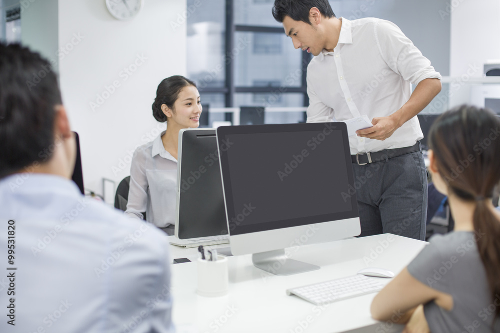 Young business people talking in office Young business people talking in office