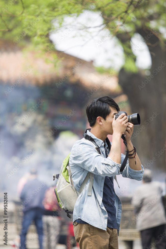 Young man taking pictures in the Lama Temple Young man taking pictures in the Lama Temple