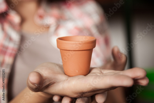 Woman showing flower pot