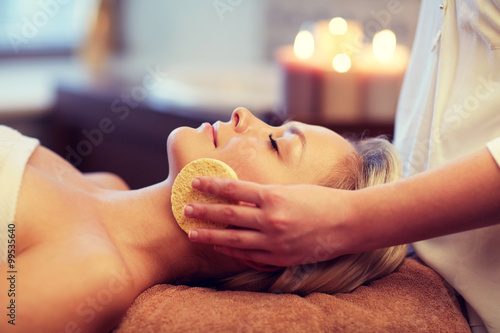 close up of woman having face massage in spa