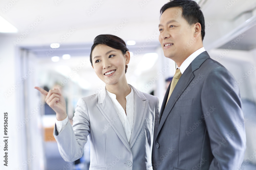 Business associates talking in subway train