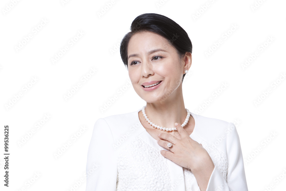 Cheerful mature woman touching her necklace Cheerful mature woman touching her necklace