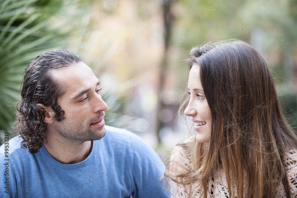 Young couple in love outdoor looking to each other Young couple in love outdoor looking to each other