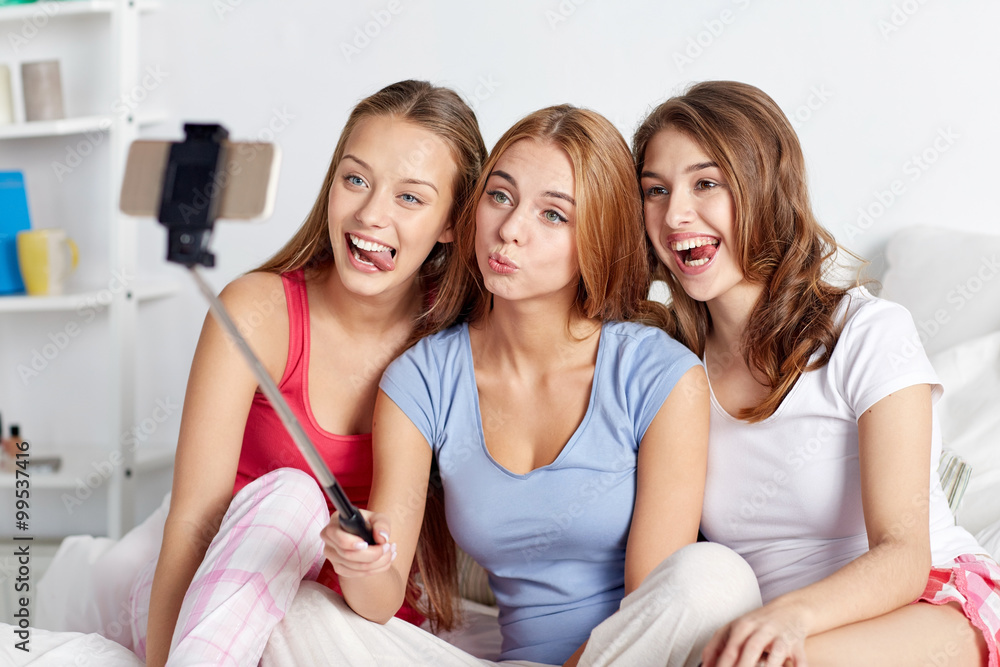 teen girls with smartphone taking selfie at home teen girls with smartphone taking selfie at home