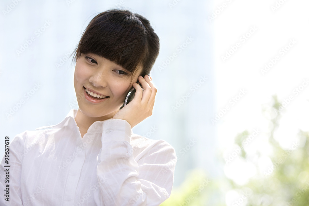 Businesswoman on phone in front of skyscraper Businesswoman on phone in front of skyscraper