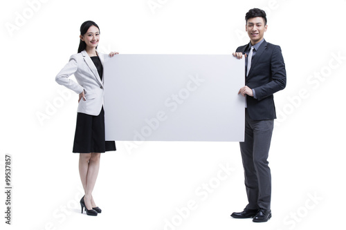 Businessman and businesswoman presenting a whiteboard