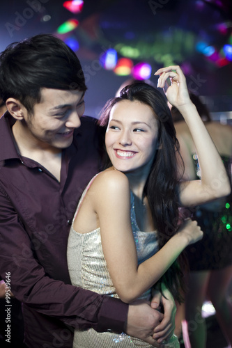 Stylish young people dancing in nightclub