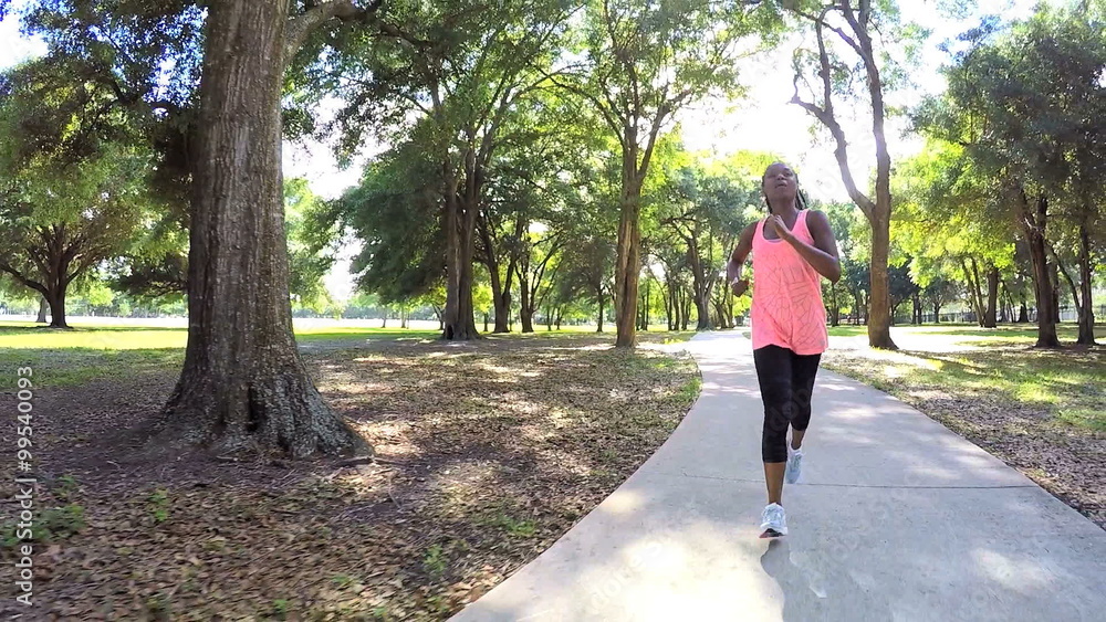 Young active African American woman jogging in park to keep healthy Young active African American woman jogging in park to keep healthy