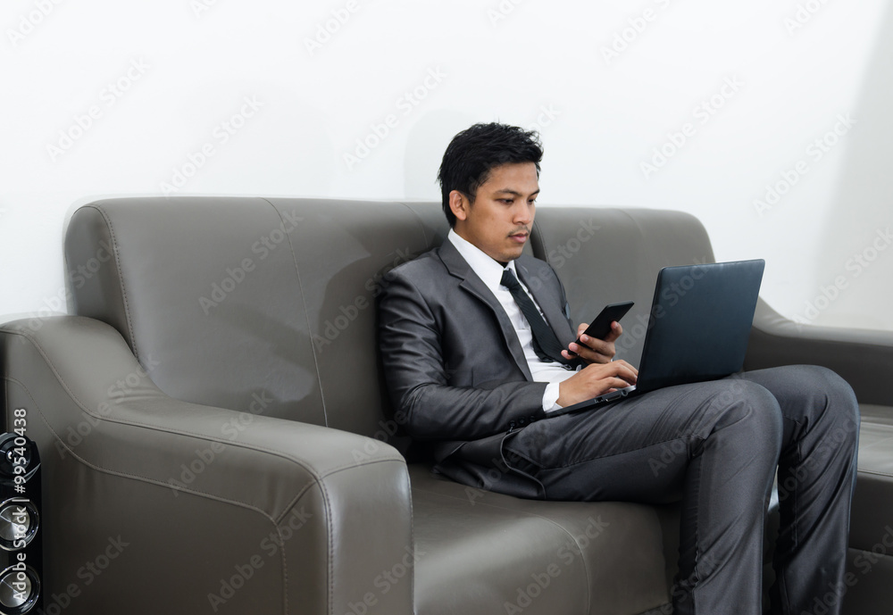 Business man working on sofa at home Business man working on sofa at home
